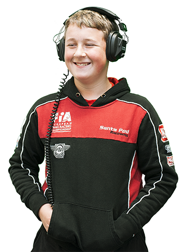 A male teenager wearing headphones, smiling